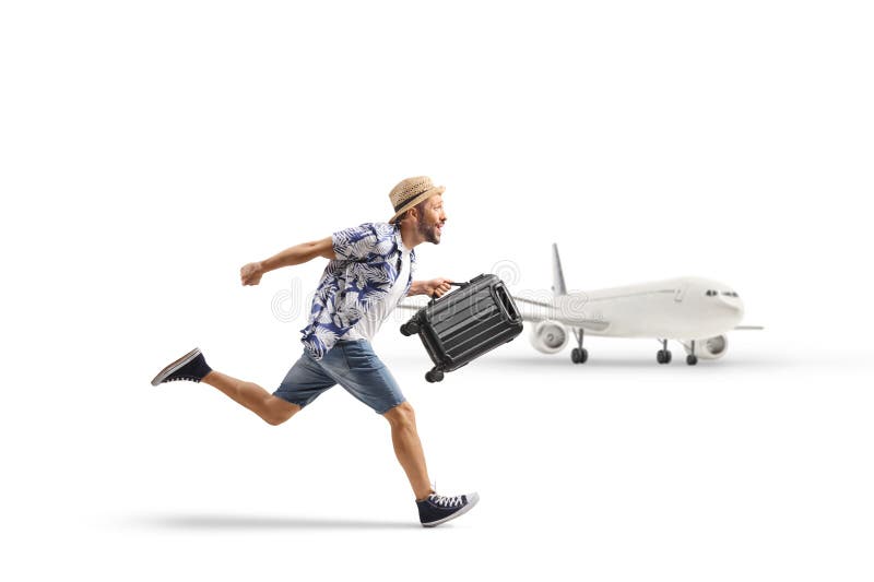 Uomo con una valigia che corre in aeroporto immagini stock libere da diritti