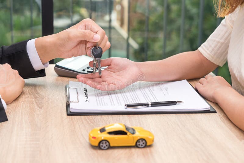 Uomo d'affari che fornisce chiave dell'automobile sopra il documento wi di applicazione di prestito dell'automobile fotografie stock libere da diritti Uomo d'affari che fornisce chiave dell'automobile sopra il documento wi di applicazione di prestito dell'automobile fotografie stock libere da diritti
