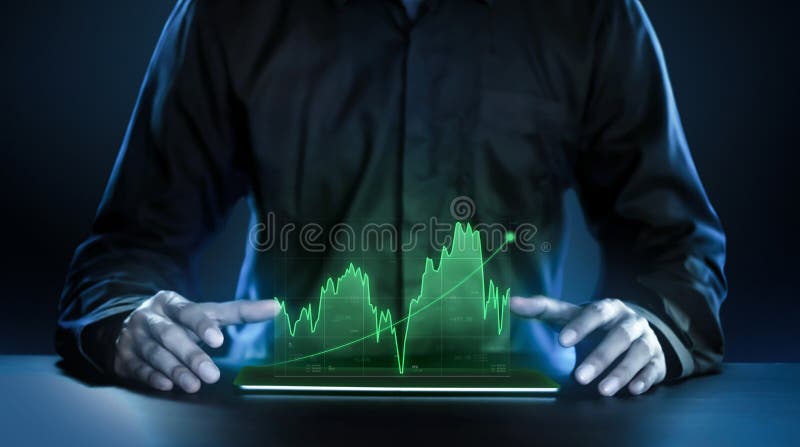 Business man showing profitable stock market holographic technology graphs in modern work background for the future. Company managers in concept planning and managing global marketing and investment. Business. Business man showing profitable stock market holographic technology graphs in modern work background for the future. Company managers in concept planning and managing global marketing and investment. Business.