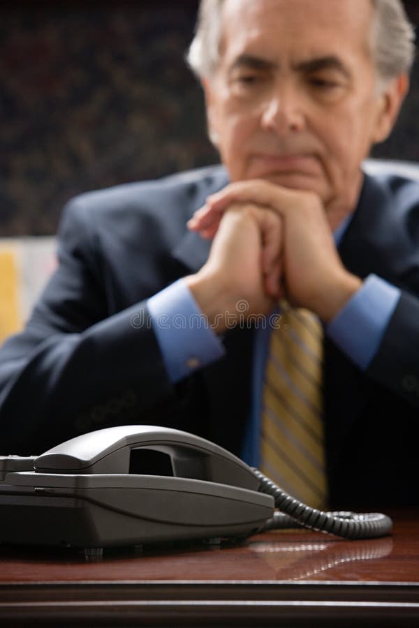 Pensive businessman with telephone. Pensive businessman with telephone