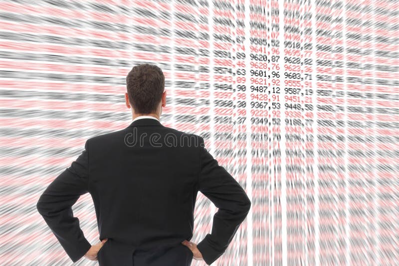 A Man in front of a big screen with numbers. A Man in front of a big screen with numbers