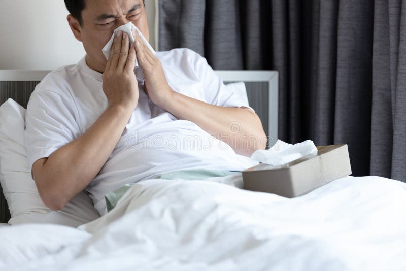 Middle aged man having allergies,hay fever,runny nose and sneeze,nasal congestion,sinusitis,blow the nose with tissue paper,inflammation of a nasal sinus,allergic rhinitis,seasonal allergy,health care. Middle aged man having allergies,hay fever,runny nose and sneeze,nasal congestion,sinusitis,blow the nose with tissue paper,inflammation of a nasal sinus,allergic rhinitis,seasonal allergy,health care