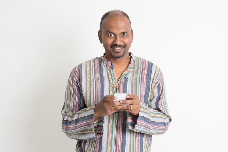 Uomo indiano casuale maturo che usando i apps mobili immagini stock