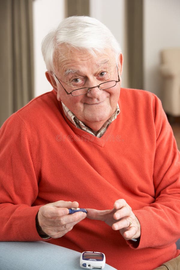 Senior Man Checking Blood Sugar Level At Home Smiling. Senior Man Checking Blood Sugar Level At Home Smiling