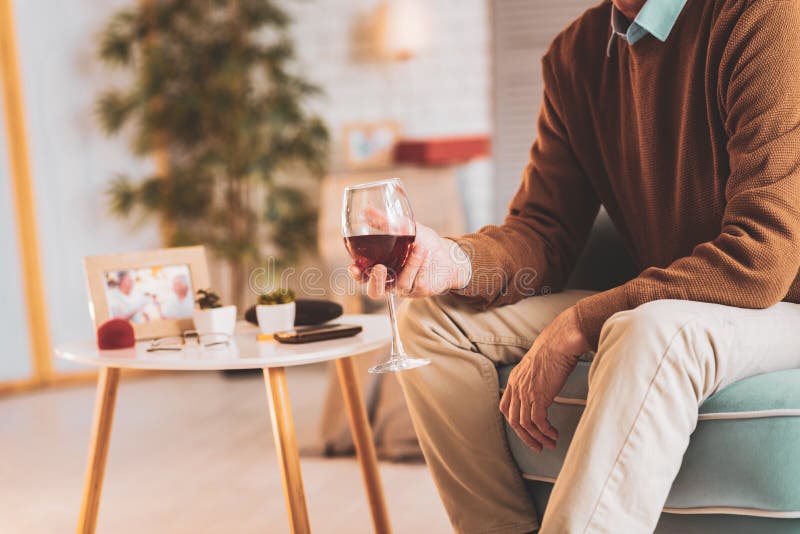 Uomo rispettoso che beve vino rosso che gode della sera piacevole immagine stock libera da diritti Uomo rispettoso che beve vino rosso che gode della sera piacevole immagine stock libera da diritti