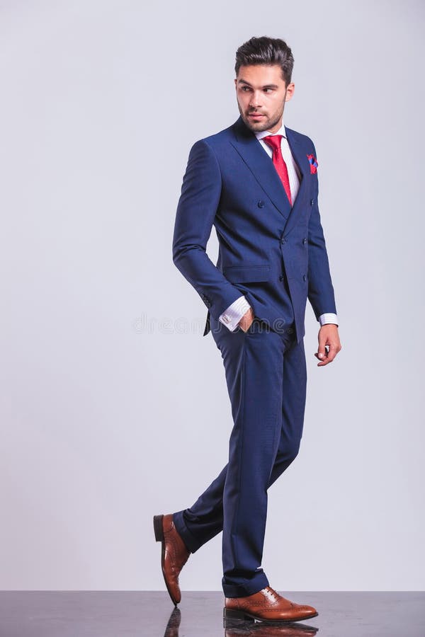 Uomo in vestito che cammina mentre distogliendo lo sguardo immagini stock libere da diritti Uomo in vestito che cammina mentre distogliendo lo sguardo immagini stock libere da diritti