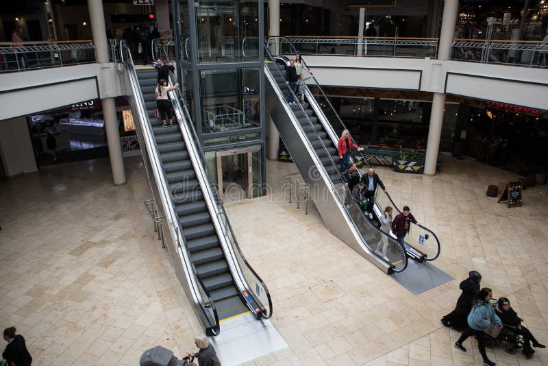 Up and down escalators inside modern shopped mall