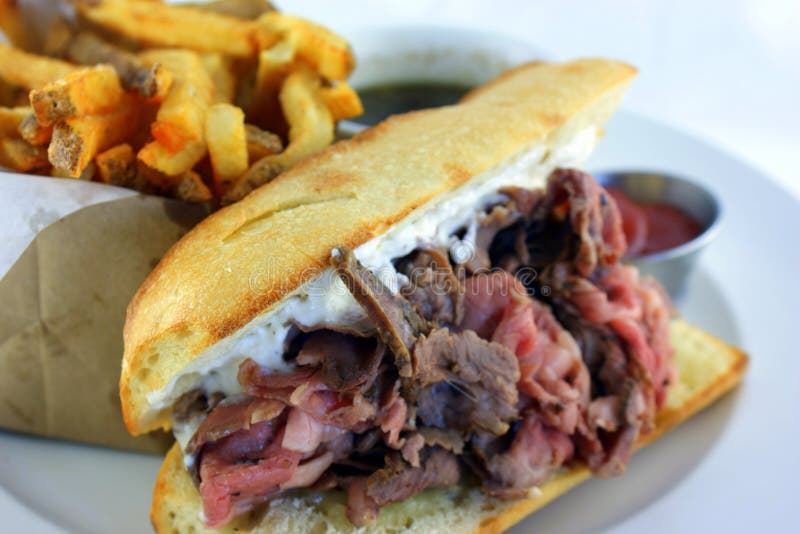 French Dip Sandwich - Juicy smoked prime rib sandwich on a crunchy French baguette smeared with horseradish sauce, and thinly sliced medium rare prime rib and Swiss cheese. French Dip Sandwich - Juicy smoked prime rib sandwich on a crunchy French baguette smeared with horseradish sauce, and thinly sliced medium rare prime rib and Swiss cheese.