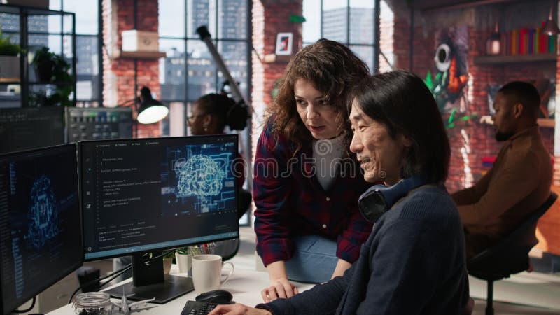 Upbeat employee asks questions to AI startup senior team leader stock video footage