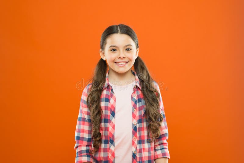 Upbringing versatile personality. Wellbeing and health. Childhood concept. Girl child stand orange background. Happy stock photography Upbringing versatile personality. Wellbeing and health. Childhood concept. Girl child stand orange background. Happy stock photography