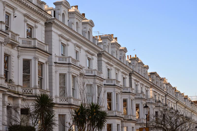 Row of upmarket houses in Notting Hill, London with many of the houses divided into luxurious flats and apartments. Row of upmarket houses in Notting Hill, London with many of the houses divided into luxurious flats and apartments.