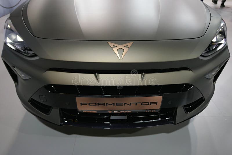 Upper front view of front mask of modern spanish compact crossover SUV car Cupra Formentor, manufactured by SEAT, in elegant matte titan bronze grey chassis, displayed on car expo in Nitra, Slovakia.