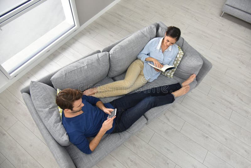 Upper view of couple lying on sofa royalty free stock images