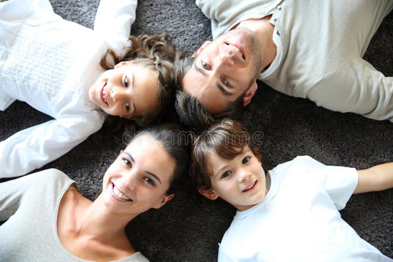 Upper view of happy family lying on carpet stock photos