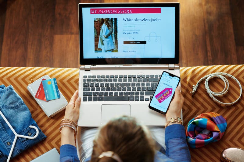 Woman browsing high fashion retail online store on laptop