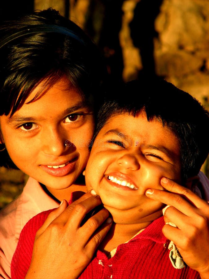 An elder cousin plays with the younger one in India. An elder cousin plays with the younger one in India