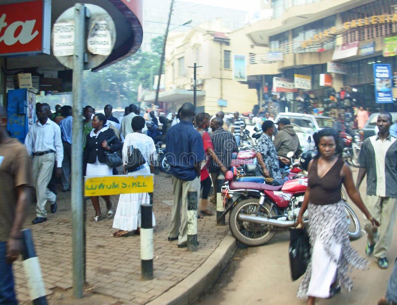 A busy metropolitan scene Uganda style, showing lots of different people in the main street going to and fro from shops, offices and work places. Photograph taken in the heart of Kampala city, Uganda, Africa. Images can be used to illustrate truthful articles in print and electronic newspapers/magazines/journals. Not to be used in commercial designs and/or advertisements. A busy metropolitan scene Uganda style, showing lots of different people in the main street going to and fro from shops, offices and work places. Photograph taken in the heart of Kampala city, Uganda, Africa. Images can be used to illustrate truthful articles in print and electronic newspapers/magazines/journals. Not to be used in commercial designs and/or advertisements