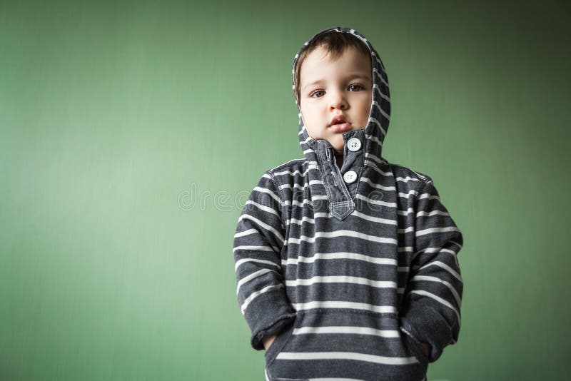 Upset cute young boy holding hands in pockets royalty free stock photo Upset cute young boy holding hands in pockets royalty free stock photo