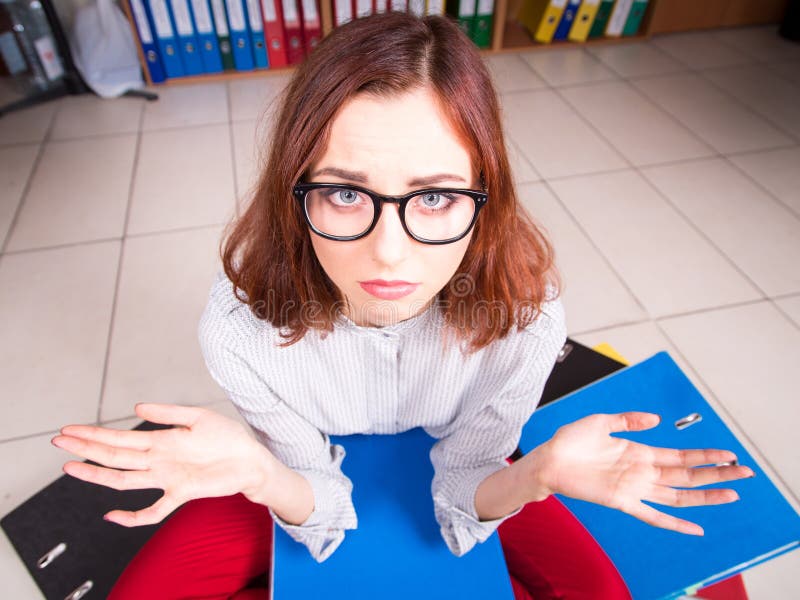 Upset girl with stack of folders stock image