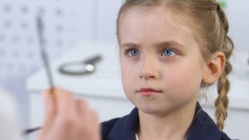 Upset little girl refusing to wear eyeglasses, corrective lenses prescription