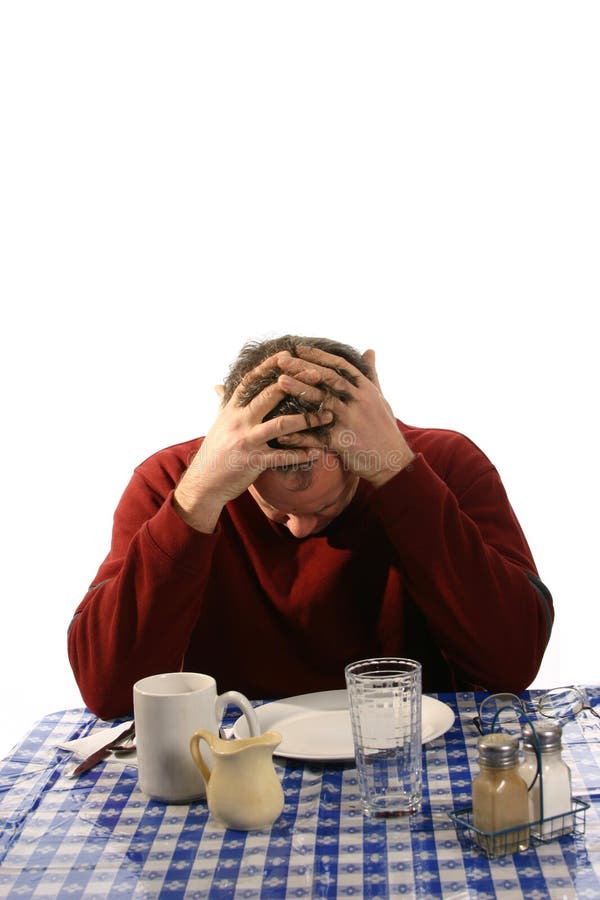 Upset man at diner with hands in mussed hair