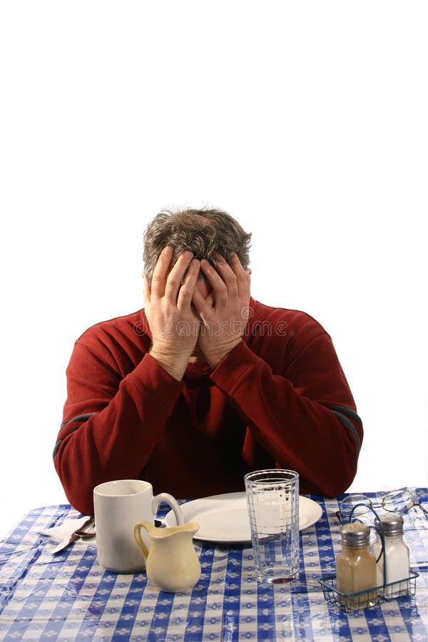 Upset man at diner with head in hands