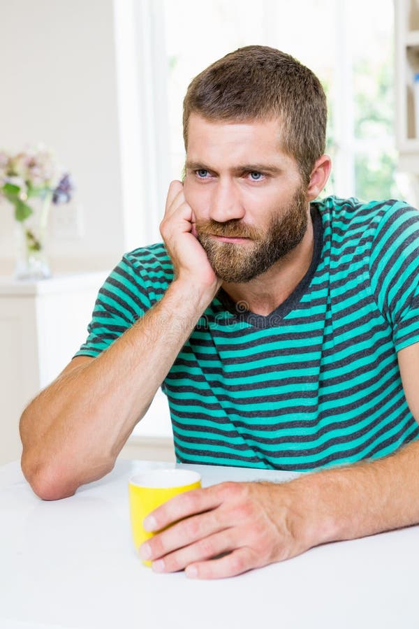 Upset Man Having Coffee in Kitchen Stock Photo Image of male