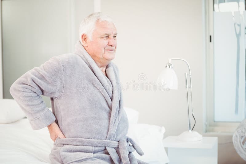 Upset Senior Man Sitting with Back Pain on Bed Stock Image Image of