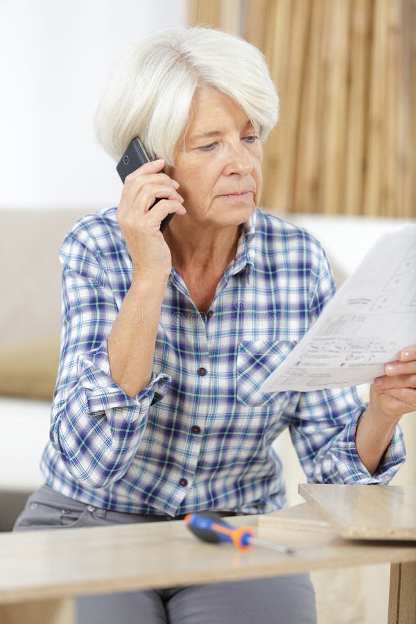 Upset senior woman with phone royalty free stock photography