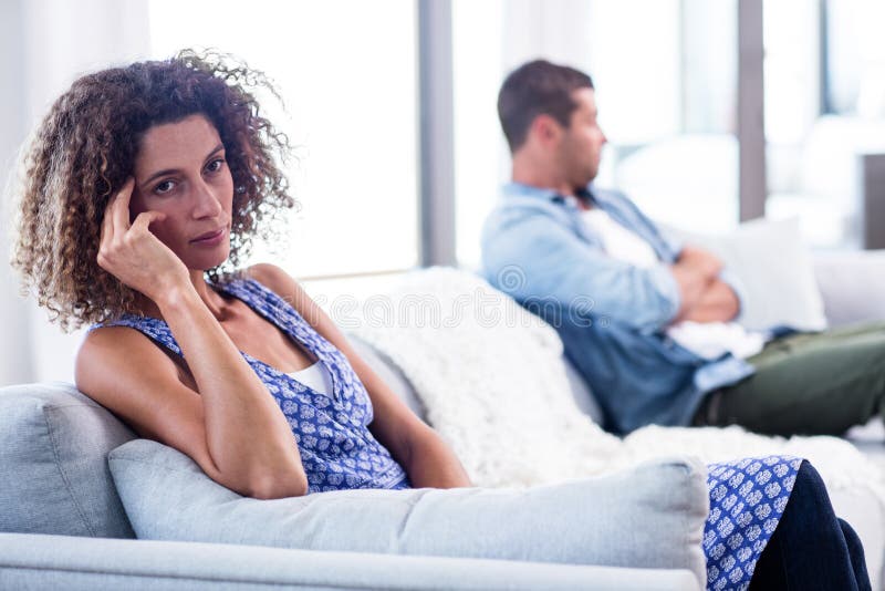 Upset young couple ignoring each other at home