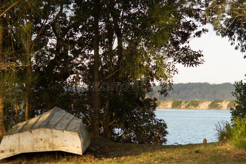 Upside Down Rowboat on the Shore of a Peaceful River in Mossy Point NSW