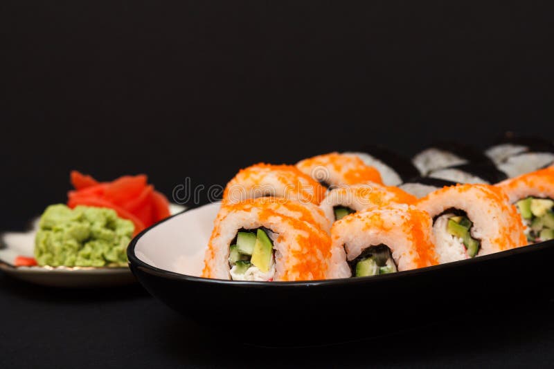 Uramaki California. Sushi rolls, plate with red pickled ginger and wasabi royalty free stock photo Uramaki California. Sushi rolls, plate with red pickled ginger and wasabi royalty free stock photo