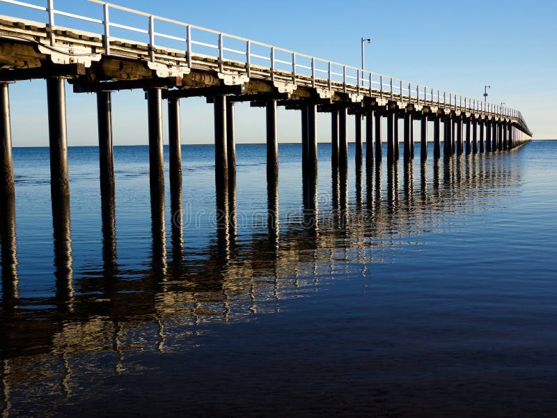 Urangan Pier and Reflection on clear blue skies and sea