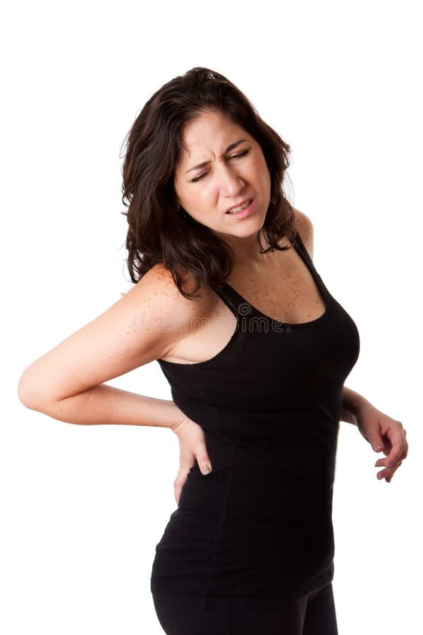 Beautiful woman holding her back with pain and ache due to injury,wearing a sporty black tank top, isolated. Beautiful woman holding her back with pain and ache due to injury,wearing a sporty black tank top, isolated.