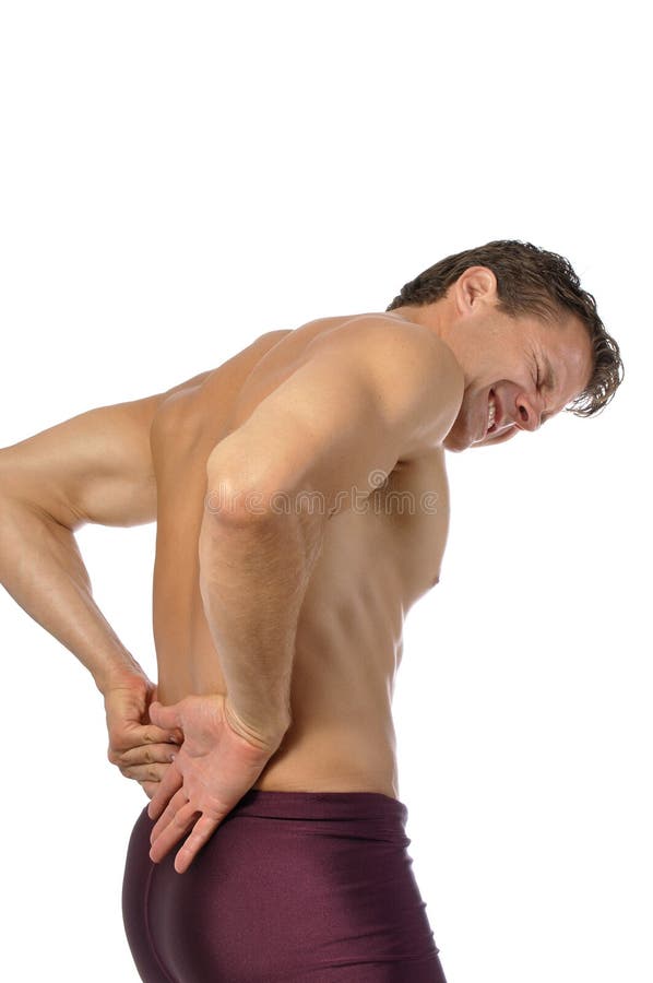 Topless athletic male suffering from excruciating lower back pain. Topless athletic male suffering from excruciating lower back pain