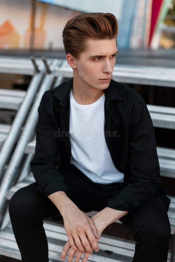 Urban Attractive Young Man with a Stylish Hairstyle in a T-shirt in an  Elegant Black Shirt in Trendy Trousers Resting Stock Image - Image of  model, caucasian: 154111059