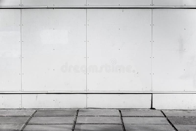 Urban background interior with white metal wall and concrete pavement