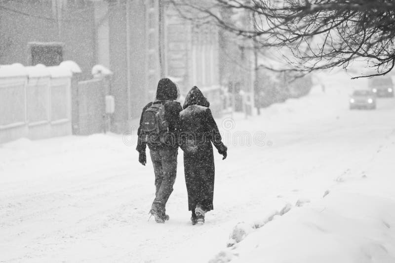 Urban landscape with couple walking in the snow royalty free stock image Urban landscape with couple walking in the snow royalty free stock image