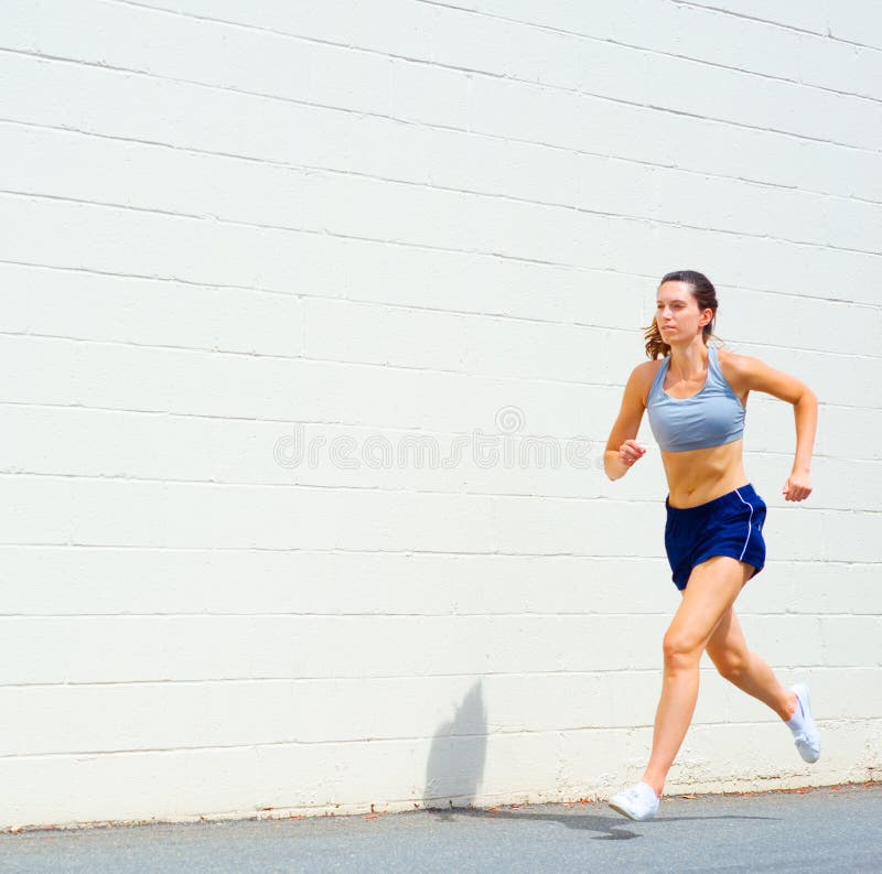 Beautiful Young Athlete Caucasian Woman with Big Breasts in Red T-shirt and Short  Shorts Jogging, Running in the Stadium with Red Stock Image - Image of  effort, equipment: 122235129