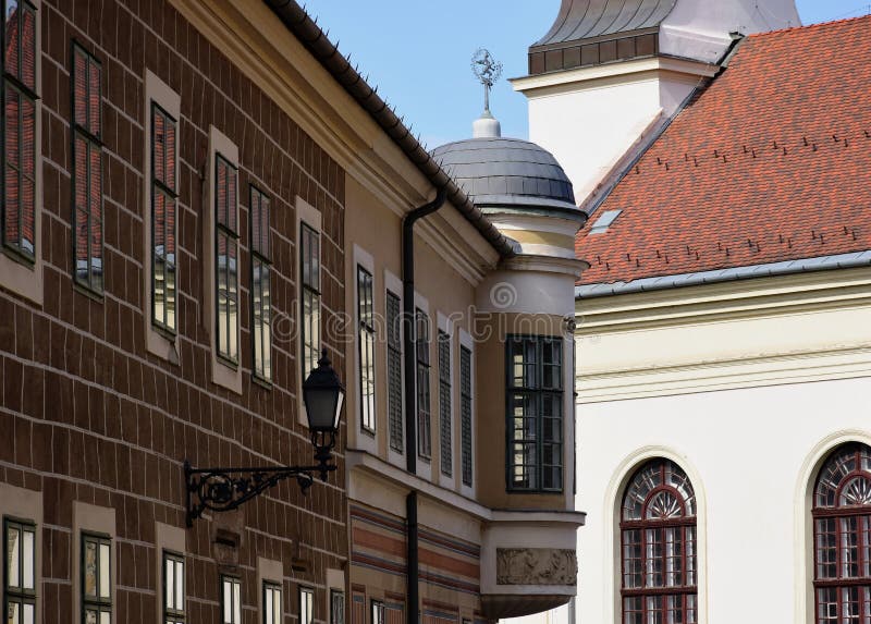 Urban street scene with old residential building facade and church facade