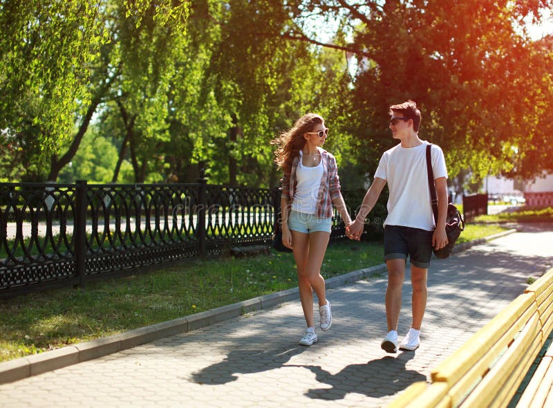 Urban young couple in love walking in sunny summer day, youth