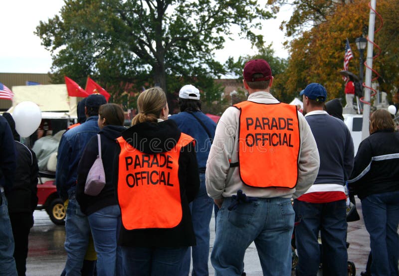 Two parade officals take a moment to watch the parade. Two parade officals take a moment to watch the parade.