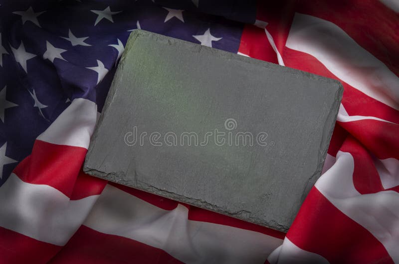US American flag on black slate stone background. USA Memorial, Veteran`s day and 4th of July celebration. Blank space for your t. Ext royalty free stock image US American flag on black slate stone background. USA Memorial, Veteran`s day and 4th of July celebration. Blank space for your t. Ext royalty free stock image