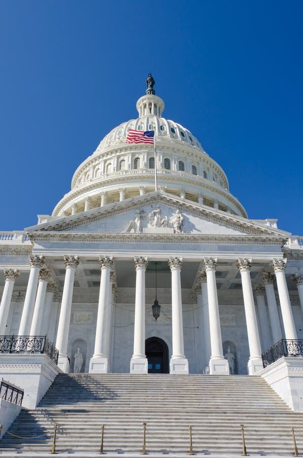 US Capitol building Entrance with US flag waves stock photography
