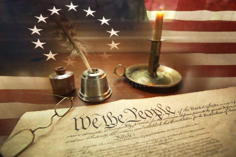 US Constitution with quill pen, glasses, candle, ink and flag