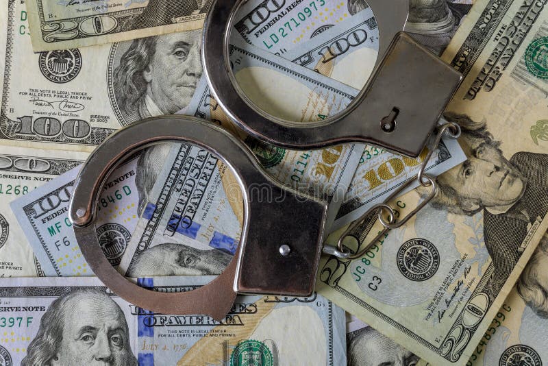 US dollar banknotes money cash corruption, dirty money financial crime of metal police handcuffs