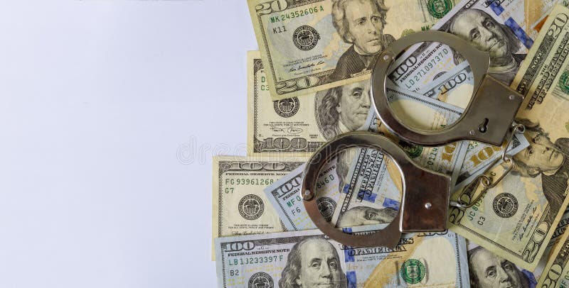 100 US dollars banknotes of counterfeit money and handcuffs