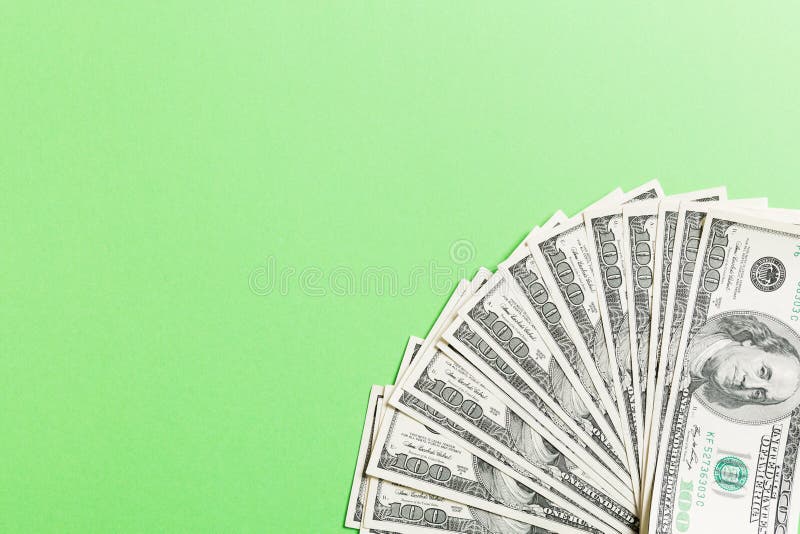 US Dollars: Untidy fan of various US dollar bills Top view of business concept on colored background stock photos