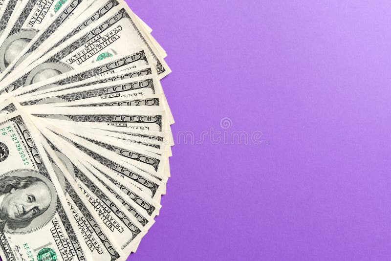 US Dollars: Untidy fan of various US dollar bills Top view of business concept on colored background royalty free stock images