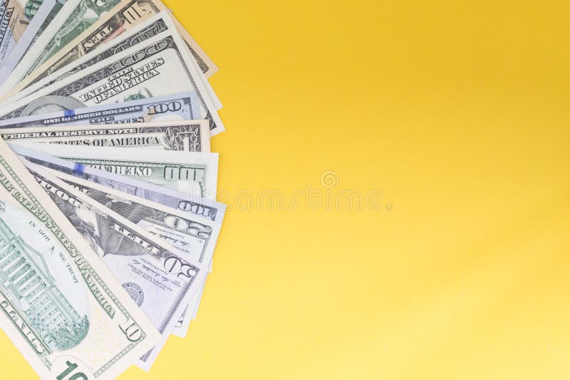US Dollars: Untidy fan of various US dollar bills Top view of business concept on colored background. royalty free stock images